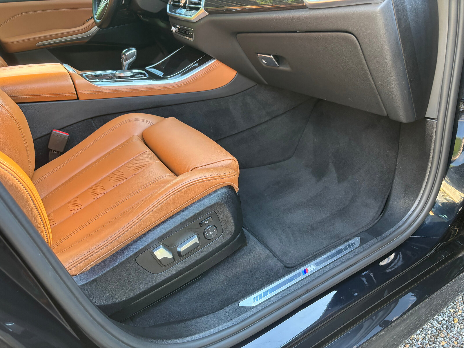 Detailed BMW tan leather interior with vacuumed carpet and floor mat — interior detailing South Jersey